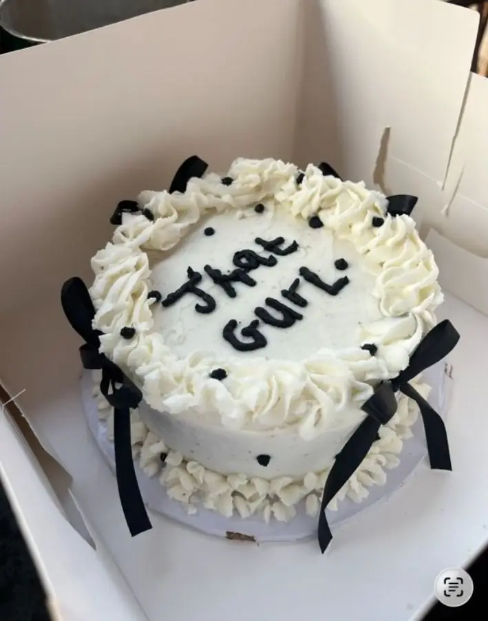 Signature white cake with black ribbon bows